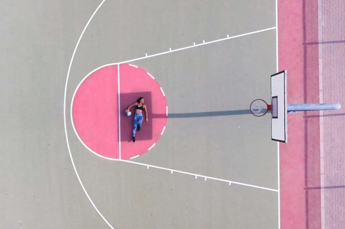 An empty basketball court in dramatic light
